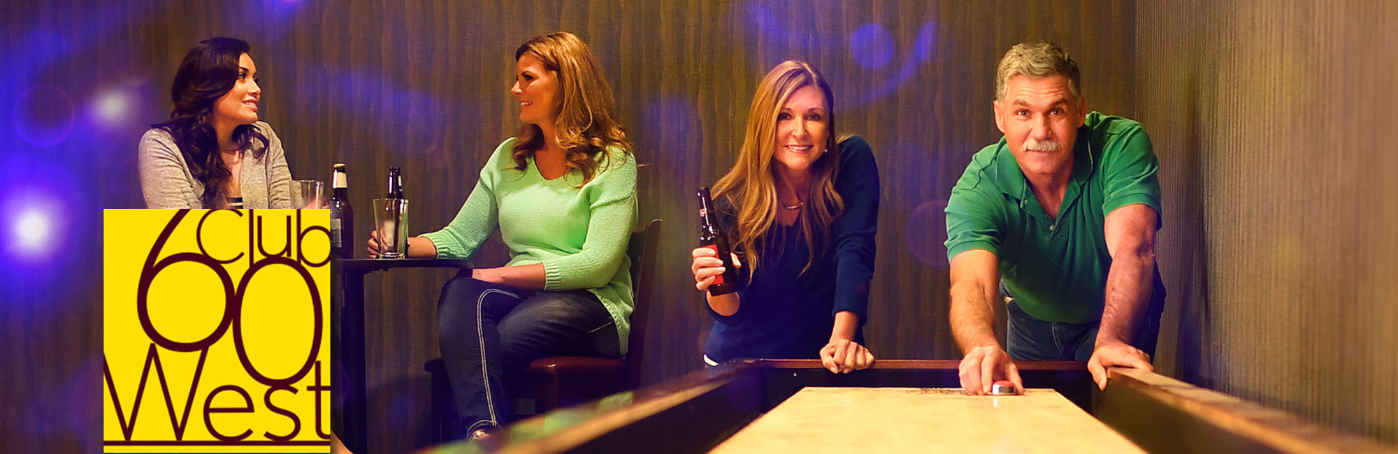 A woman and man playing shuffleboard