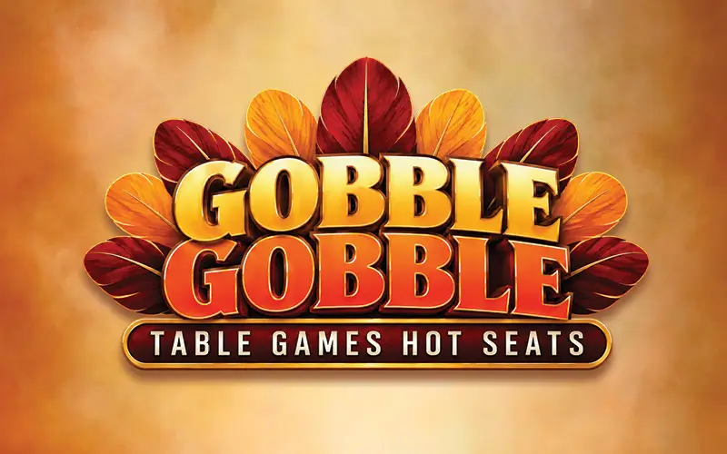 Gobble Gobble Table Games Hot Seats promotional logo featuring bold gold and orange lettering surrounded by red and golden turkey feathers against a warm autumn background.
