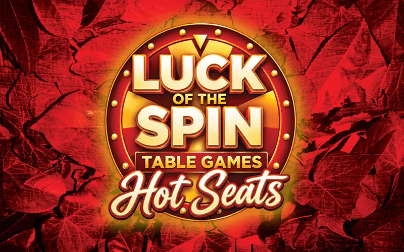 Luck of the Spin Table Games Hot Seats promotional logo featuring gold and red lettering inside an illuminated circular emblem against a textured red autumn background with fall leaves.