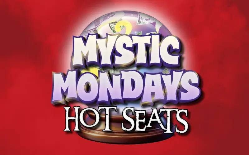 Mystic Mondays Hot Seats promotional logo featuring bold white and lavender lettering over a glowing crystal ball filled with dollar bills against a bright red background.